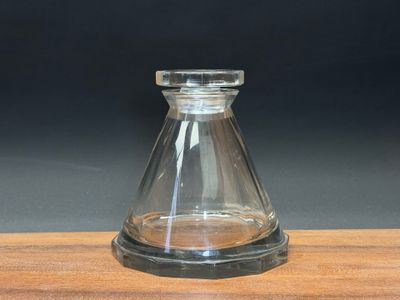 a small glass vase on a wooden table