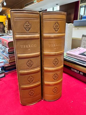 two books that are sitting on a red carpet