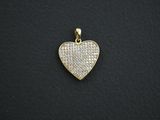 a gold heart pendant with white diamonds on a black background
