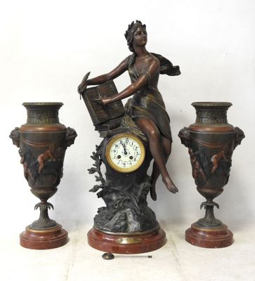 a statue of a woman sitting on top of a clock next to three vases