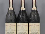 three bottles of wine are lined up on a table