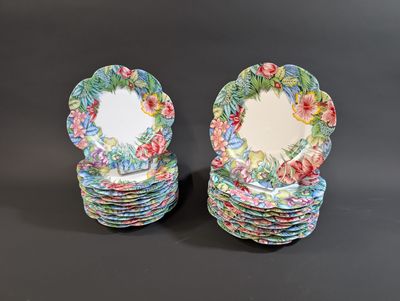 two plates with floral designs are stacked on top of each other