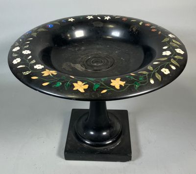 an image of a black plate with flowers and leaves on it