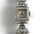 a close up of a wrist watch with diamonds on it