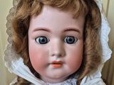 a close up of a doll with a bonnet on