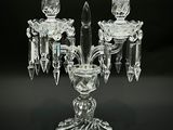 a glass candelab with a candle holder on it