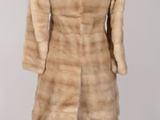 an image of a woman ' s fur coat on a mannequin stand