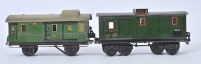 two toy trains sitting side by side on a white surface