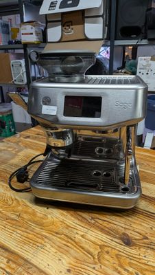 a coffee machine sitting on a wooden table in a room