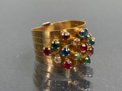 a gold ring with multi colored stones on it