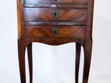 an image of a small wooden table with drawers on it