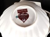 a close up of a white plate with a heart on it