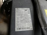 a label on the back of a suitcase that is sitting on the floor