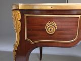 a small table with a gold decoration on top of it