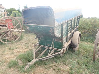 une remorque verte garée dans l'herbe