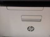 the printer is sitting on top of the paper tray in the room