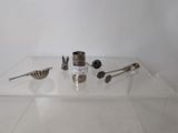a glass display case with silver objects on it