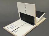 an open book sitting on top of a table with a pen in it