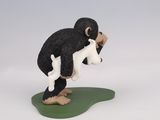 figurine of a black and white monkey holding a baby animal