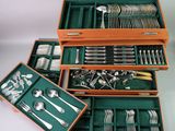 many different types of silverware in a wooden box