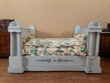 a dog bed that is sitting on a wooden floor