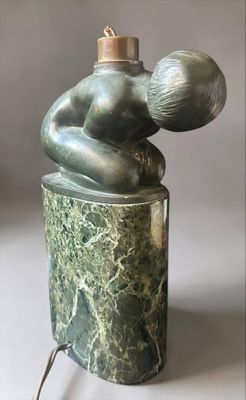 statue of a woman holding a baby on a green marble base