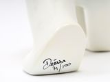 a close up of a white vase with writing on it