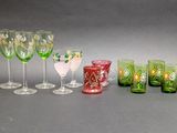 many different colored glasses and cups on the table