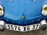 a close up of a blue car with a number plate on it