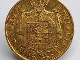 l'image d'une pièce d'or sur laquelle figurent des armoiries