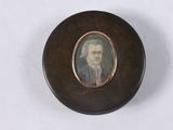 an old picture of a man in a suit and tie in a wooden box