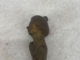 statue of a woman in a hat on a snow covered ground