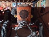 a tractor that is sitting under a wooden structure