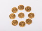 un groupe de pièces d'or sur une surface blanche
