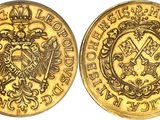 a gold sovereign coin with a crown on the front and a shield on the back