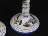 pair of blue and white vases with flowers on them against a black background