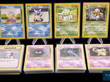 several pokemon cards are lined up on a black surface