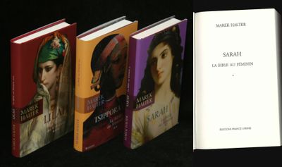 several books are lined up in a row on a black surface