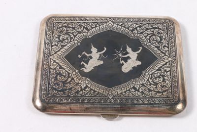 un étui à cigarettes ancien en argent, orné d'un motif en noir et blanc sur le devant
