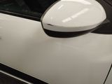 a close up of a car ' s side mirror with a sticker on it