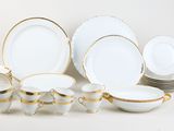 a lot of white and gold plates and cups and saucers