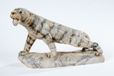 marble statue of a tiger on a rock on a white background