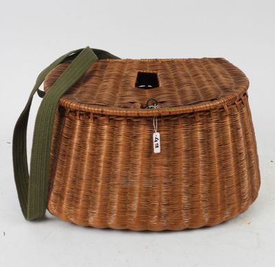 a close up of a wicker basket with a green strap