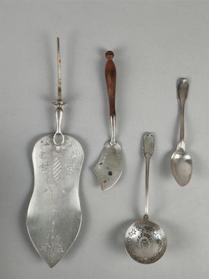 three spoons and a spoon rest next to each other on a table