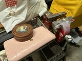 a pink purse sitting on top of a table next to other items