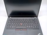 the laptop is open on a white surface with a black keyboard
