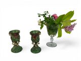 three vases with flowers in them sitting next to each other