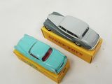 two toy cars that are sitting on top of a box