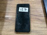 a cell phone sitting on a table next to a laptop