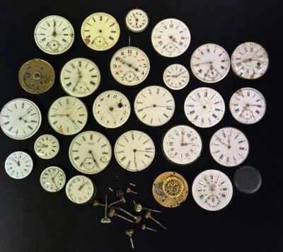 many different types of clocks on a black surface